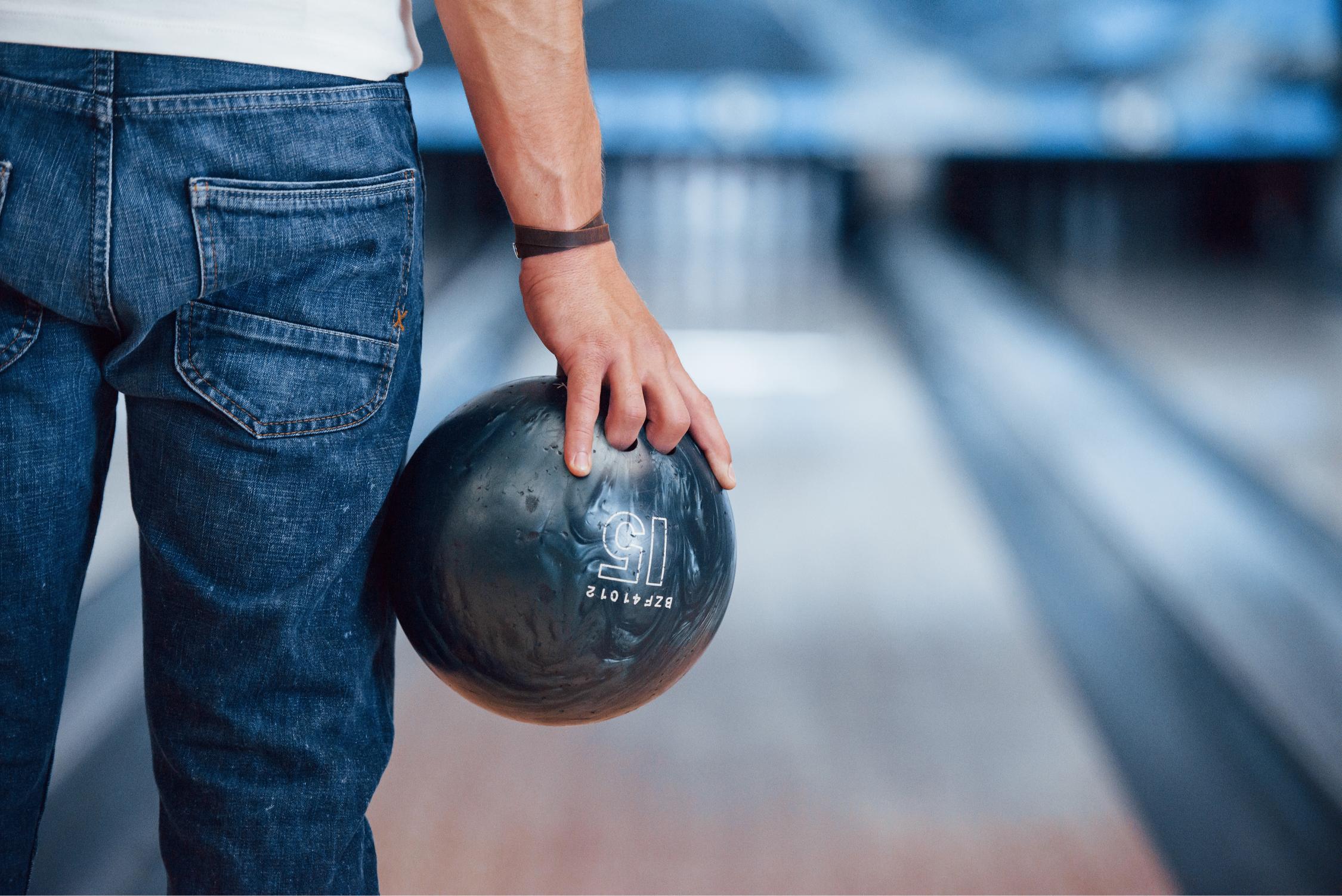 artificial-lighting-rear-particle-view-man-casual-clothes-playing-bowling-club